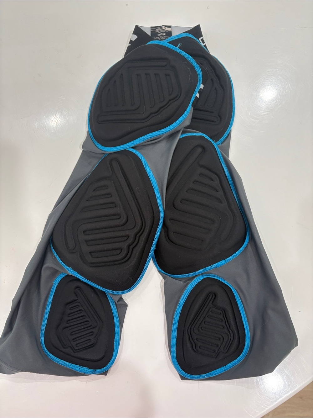 Men's Protective Compression Sleeve with Black Padding and Blue Trim